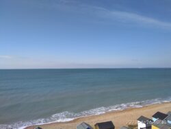 The view of the bright blue ocean and the sky along a Dorset beach